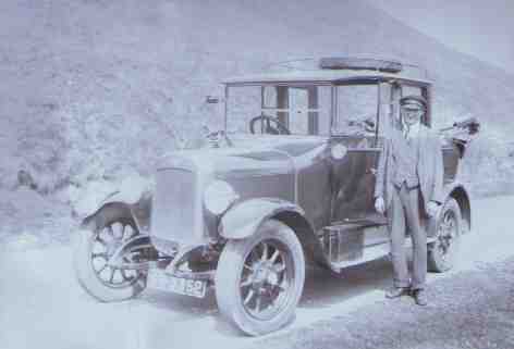 Billy Jameson standing beside his taxi, circa 1925