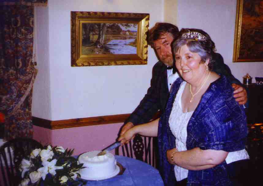 Mr. and Mrs. Barry Armstrong cut their wedding cake
