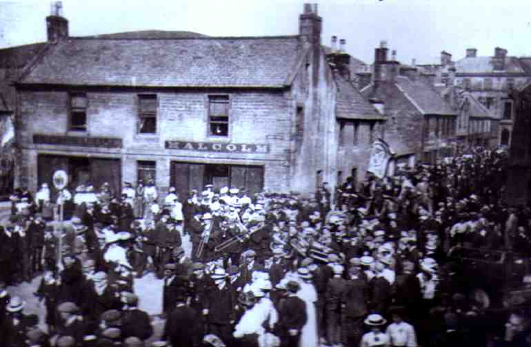 The Cornet accompanied by his right and left men lead the Common Riding street procession in 1908